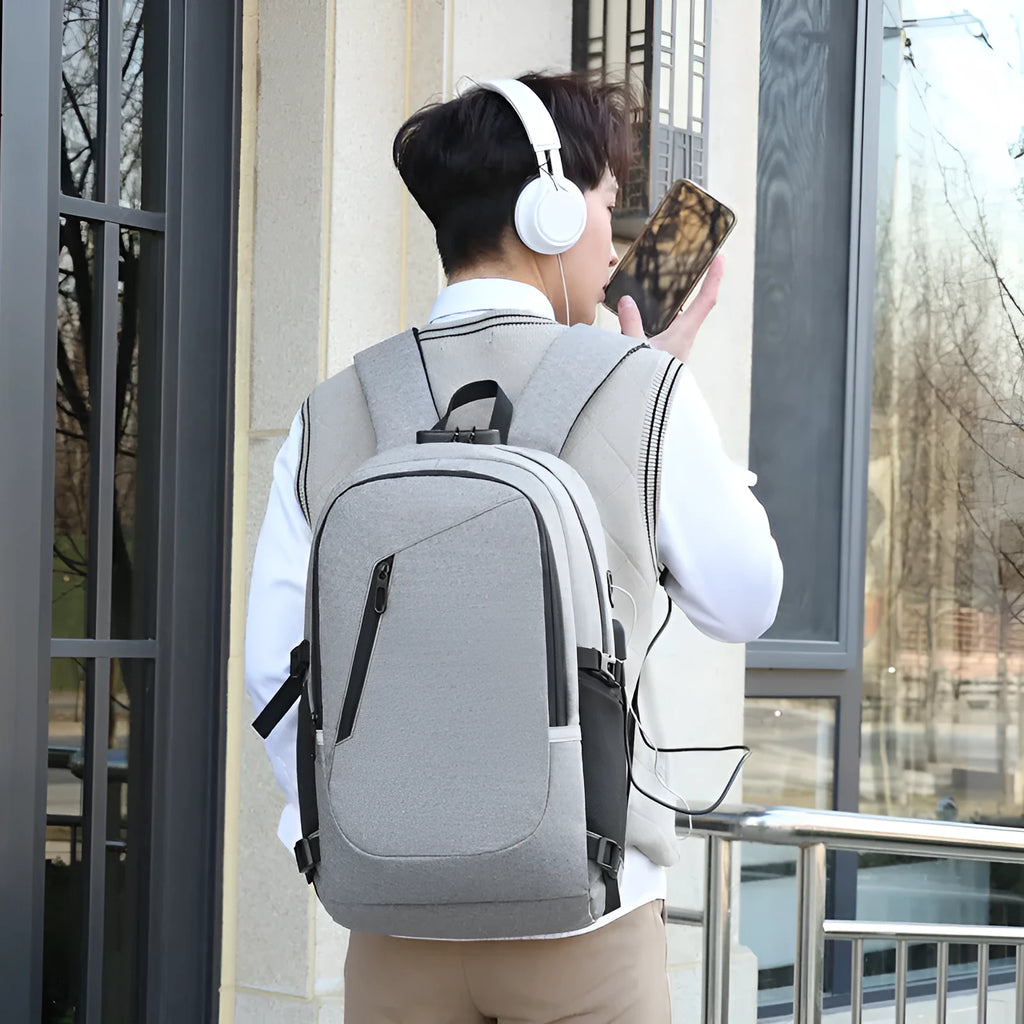 Grey Oxford cloth computer backpack with front pocket and adjustable straps, shown with laptop compartment open.