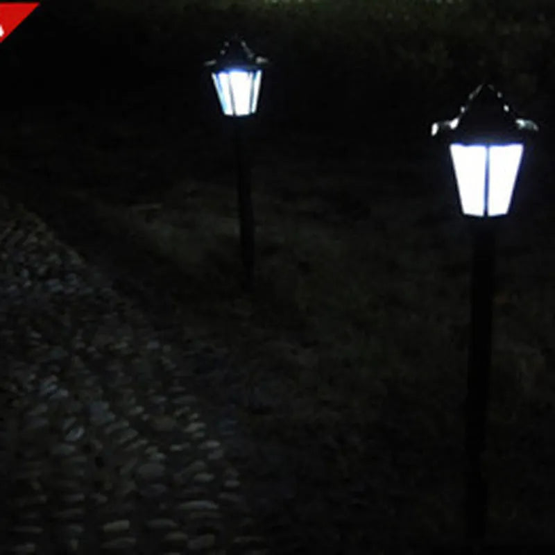 Outdoor solar hexagonal wall light in garden setting, available in white or yellow light, with ground plug or wall hanging style