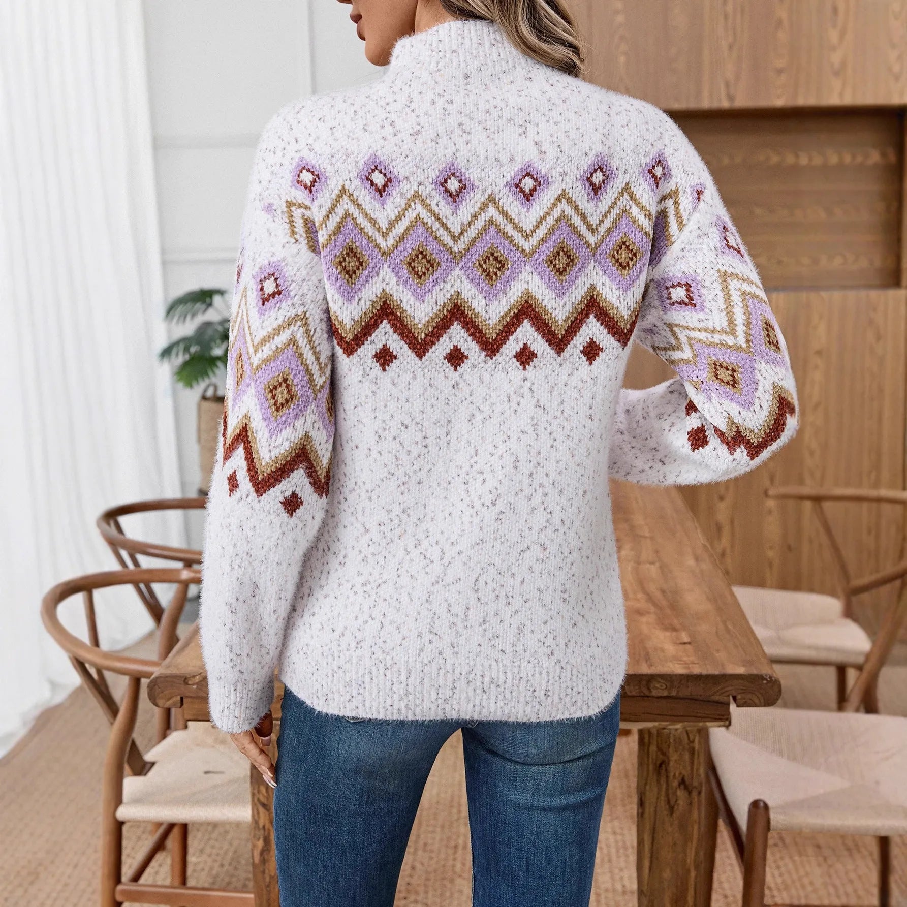 White women's loose geometric jacquard sweater with half turtleneck on hanger
