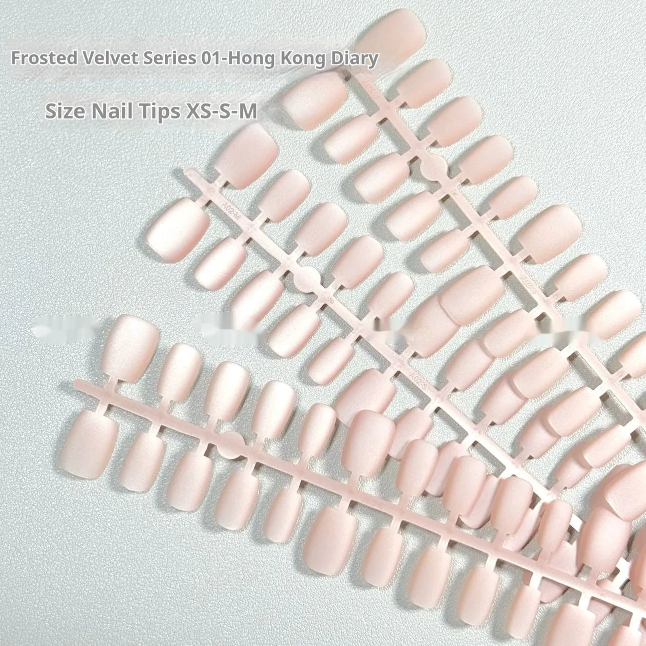 Set of frosted velvet Cat's Eye artificial nail tips in short ladder sizes on a display card.