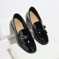 Patent leather square toe loafers in black with low heel and rubber sole