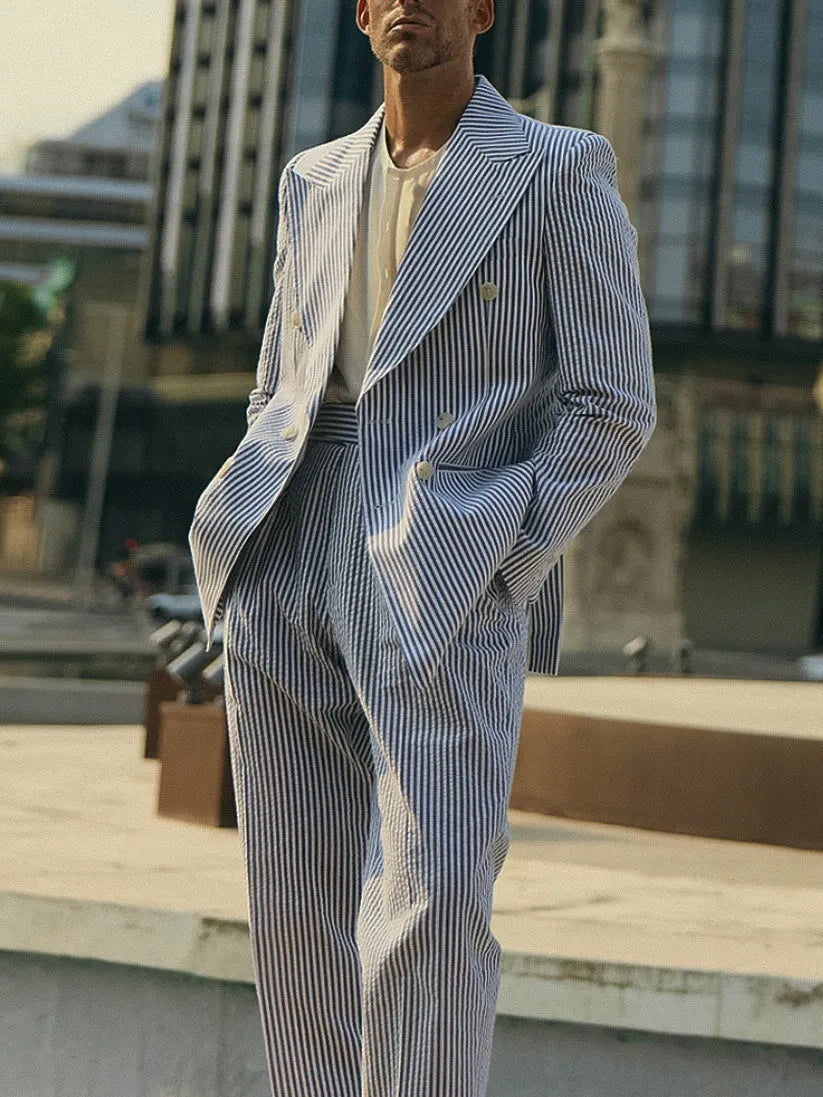 Blue and white striped polyester blazer and trousers suit set on a hanger