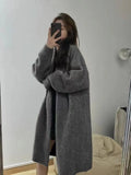Women's khaki mid-length knitted cardigan with V-neck and long sleeves laid flat.