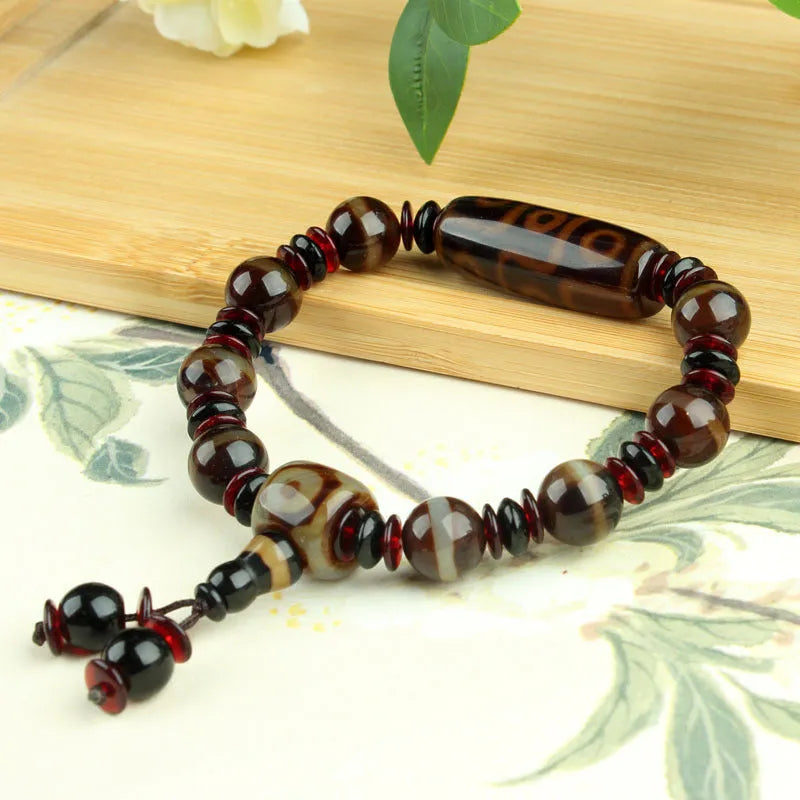 Distressed agate Tibet beads bracelet with three eye dzi design and polished stone beads