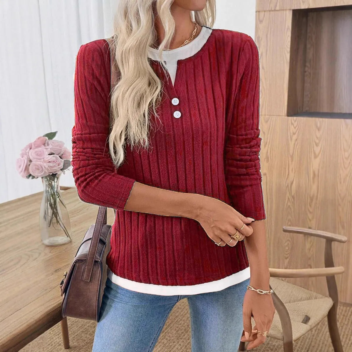 Women's black fake two-piece round neck pullover sweater with concave stripe texture and button details.