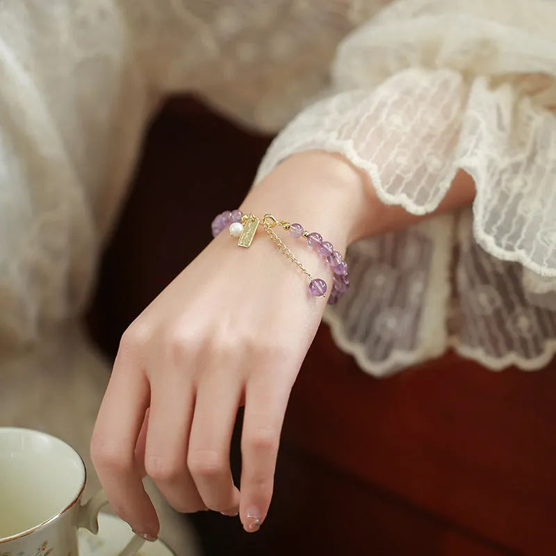 Natural crystal lavender amethyst bracelet for women in dark and light colour variations on a wrist.