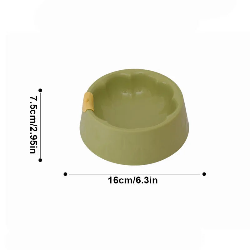 Green plastic double pet bowl for food and water with a flower-shaped, anti-tipping design.