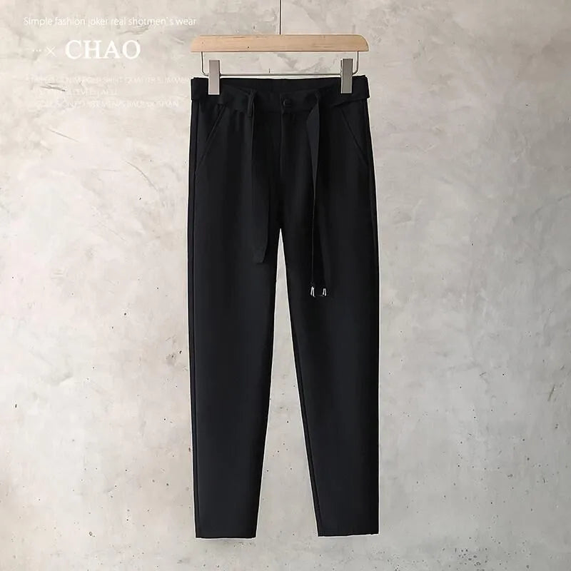 Boy wearing slim straight tapered wool trousers in grey for a business casual outfit.