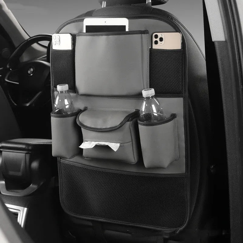 Leather car seat back storage organiser bag shown in black, suspended behind a car seat headrest.
