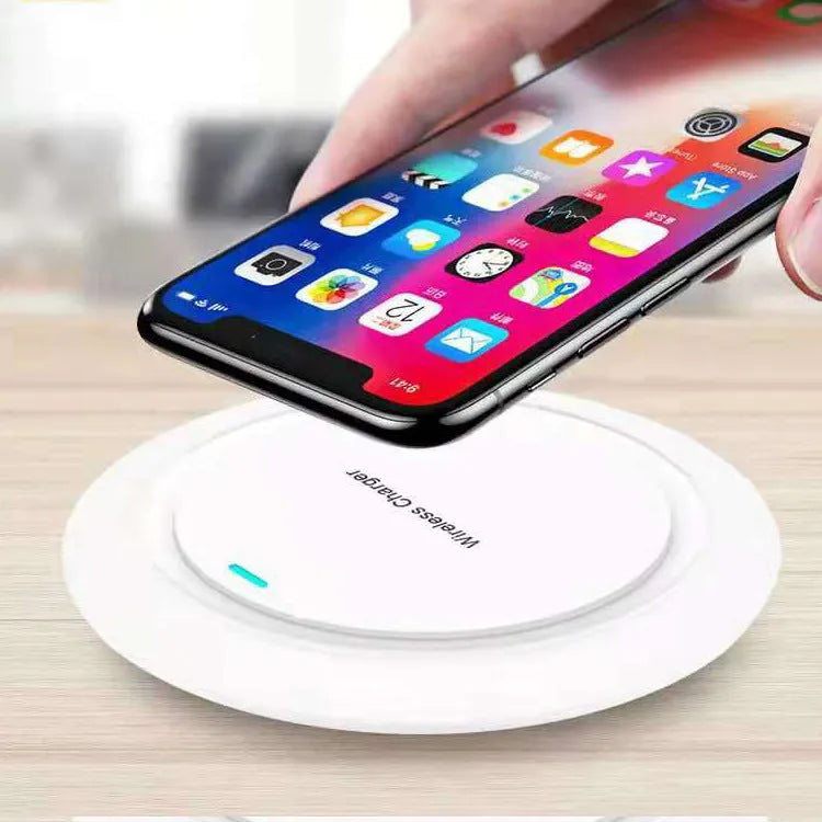 Round white desktop wireless charger with USB cable showing 10W fast charging for mobile phones