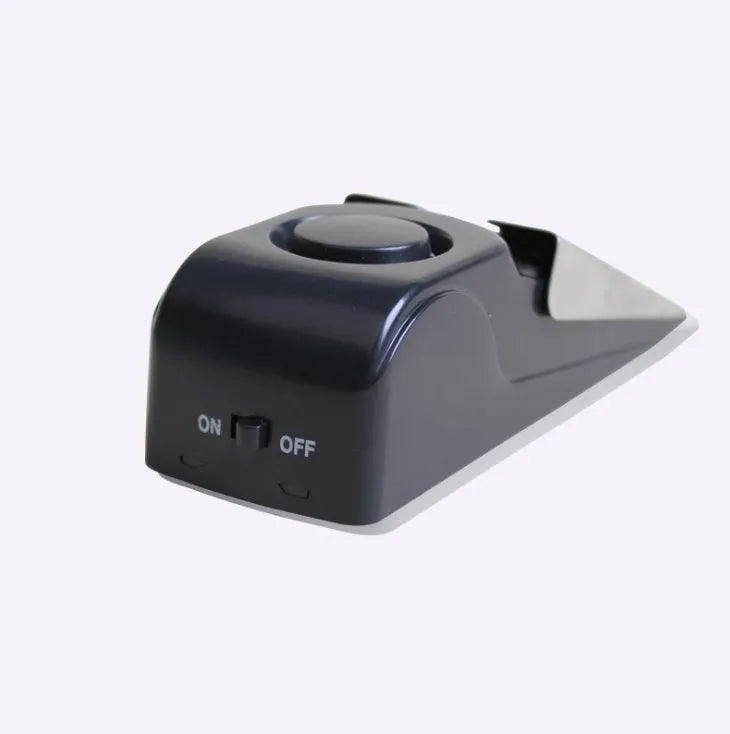 Black wedge door stop alarm with 120 dB siren, vibration sensor and stainless steel cover, for hinged doors