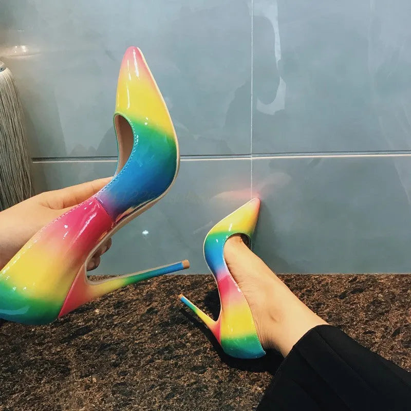 Rainbow glossy patent leather women's ultra-high heel shoe with pointed toe and thin heel.