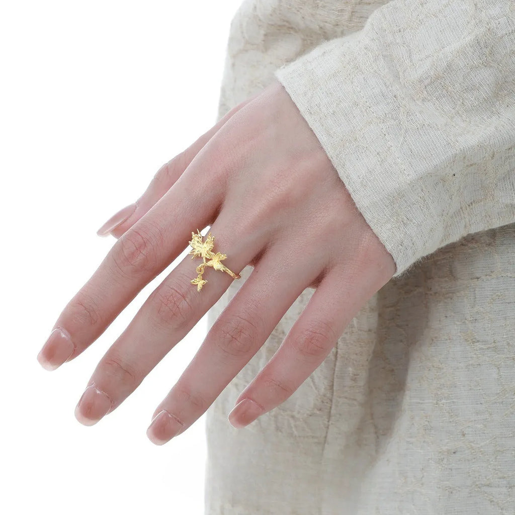 Adjustable silver ring with a detailed butterfly design in a choice of white gold or gold colour finish.