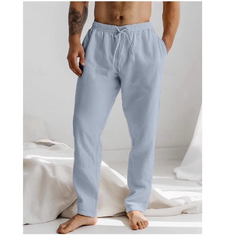 Men's light grey loose-fit cotton linen summer trousers with an elastic drawstring waist and straight legs.