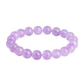 Lavender amethyst round bead bracelet with water ripple pattern on a table.