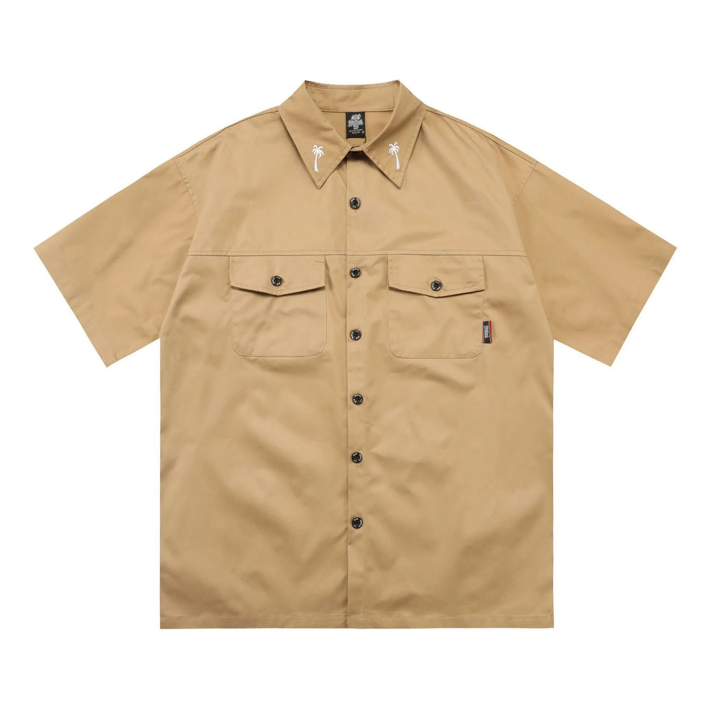 Man wearing a black loose-fit cotton blend embroidered pocket shirt with half-length sleeves.