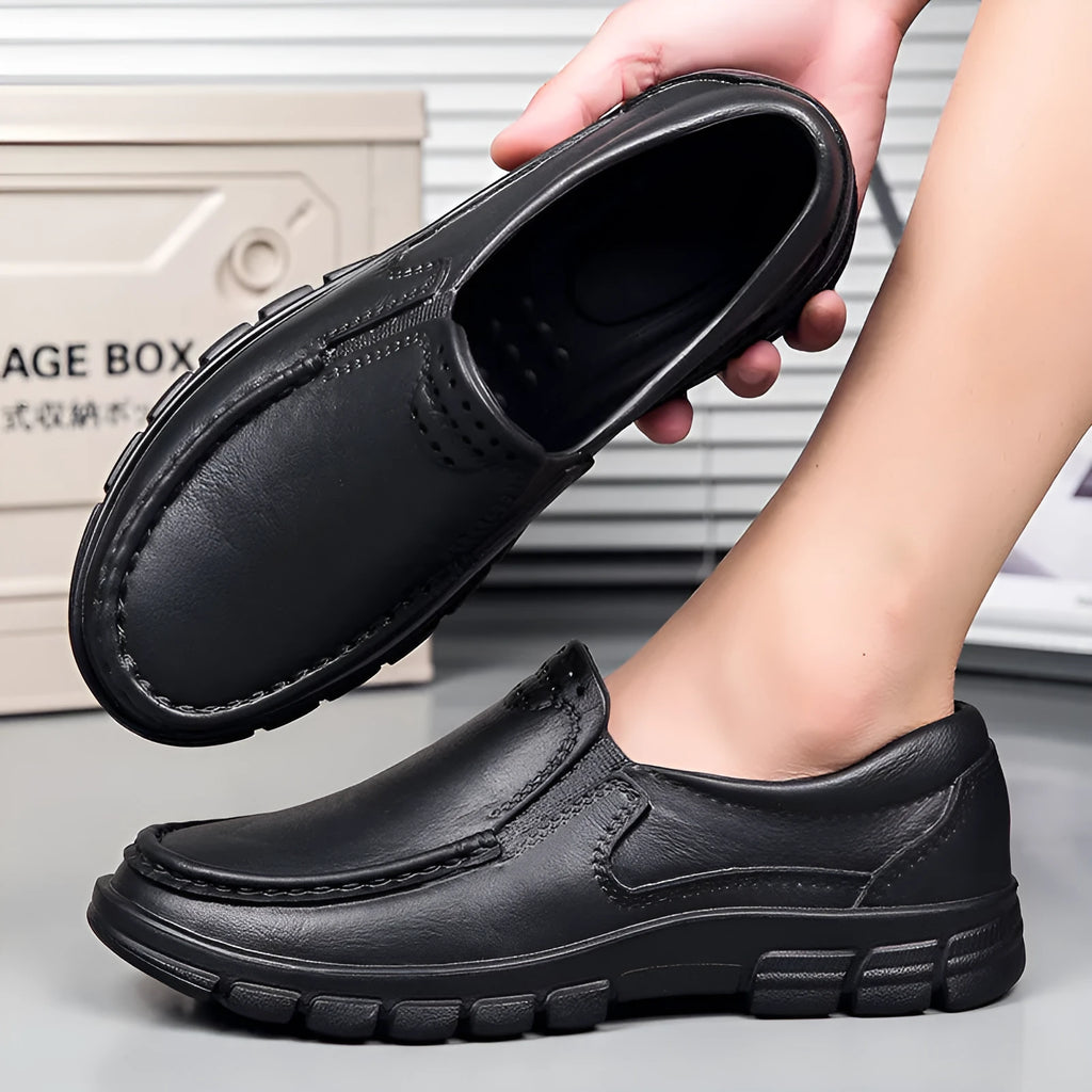 Men's black slip-on casual shoes with a waterproof platform sole and round toe.