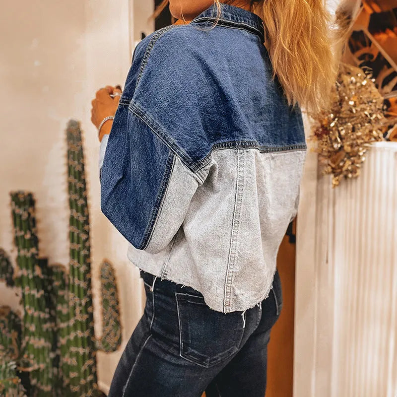Blue women's loose fit denim coat with a single row of multiple buckles down the front.