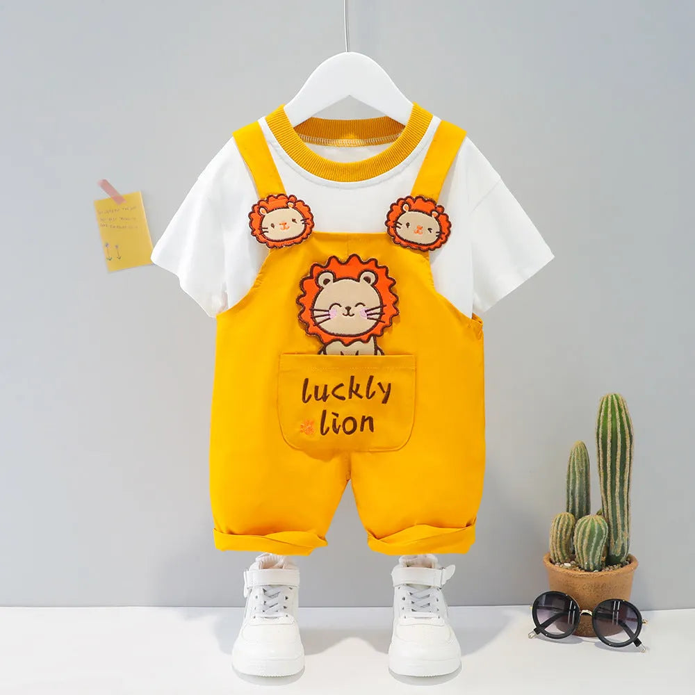 Baby wearing yellow cotton short-sleeved overalls with cartoon design and adjustable straps.