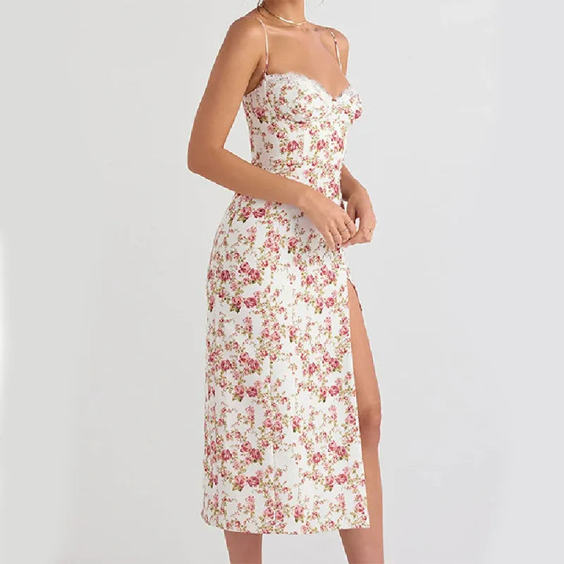 Women's blue lace flower print long dress with thigh slit and black suspender straps.