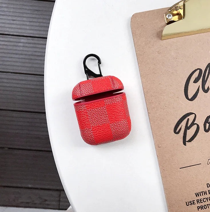 Hard plastic iPhone XS Max case with a hook for a Bluetooth headset, shown in a grid pattern design.