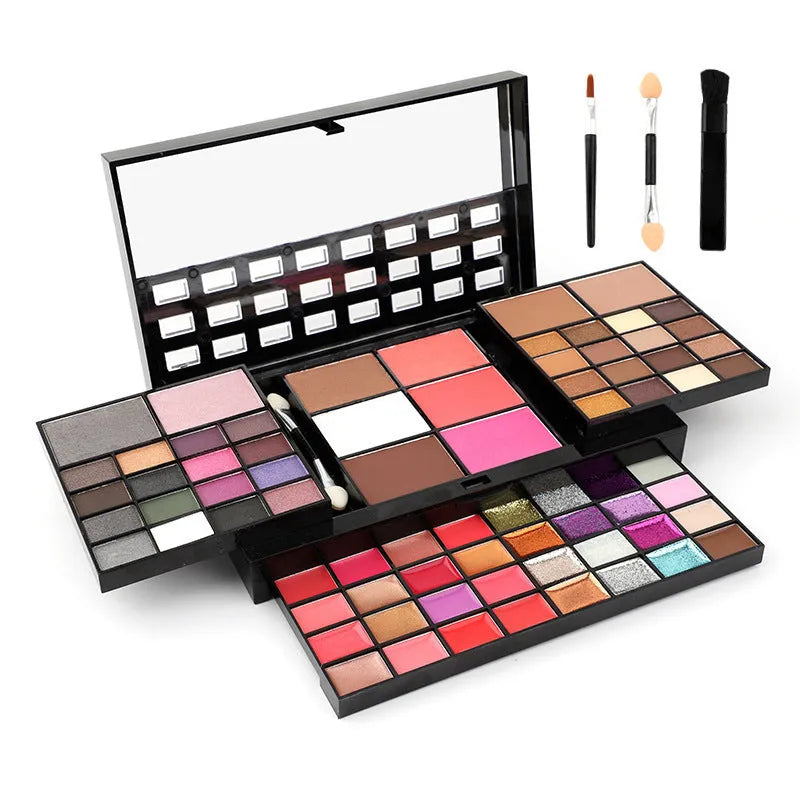 74 colour makeup palette open showing layered powder plates with eyeshadows, lip glosses, blush and contour, with mirror and brushes.