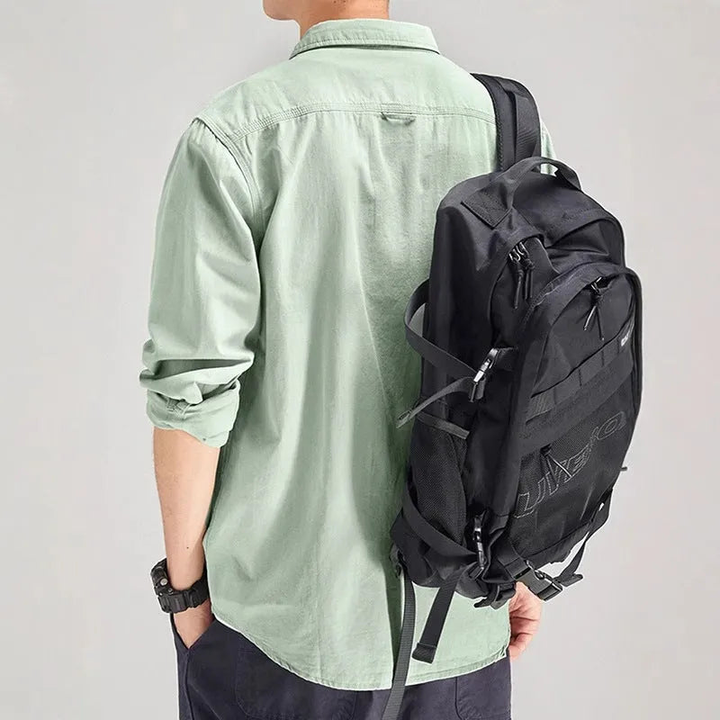 Man wearing a loose fit long sleeve cardigan shirt in light grey polyester.