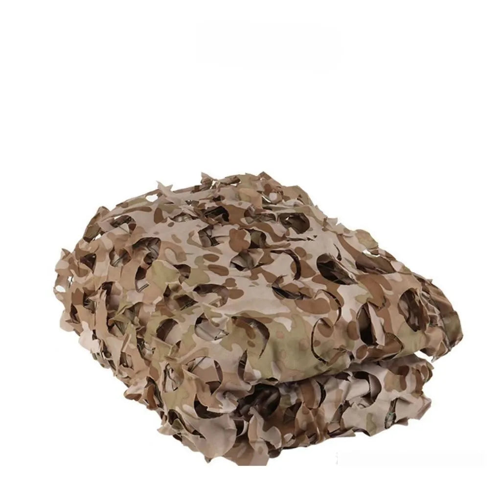Green camouflage net cover on a forest floor, showing a multi-spot leaf pattern.