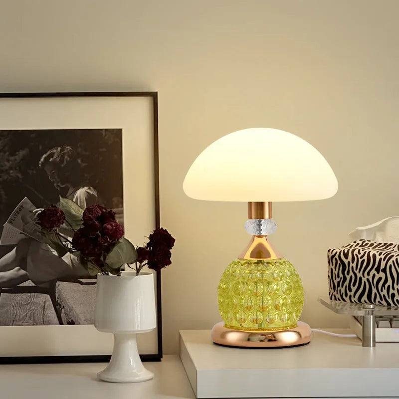 Light luxury mushroom table lamp in transparent colour option on a bedroom desk with USB cable connected.