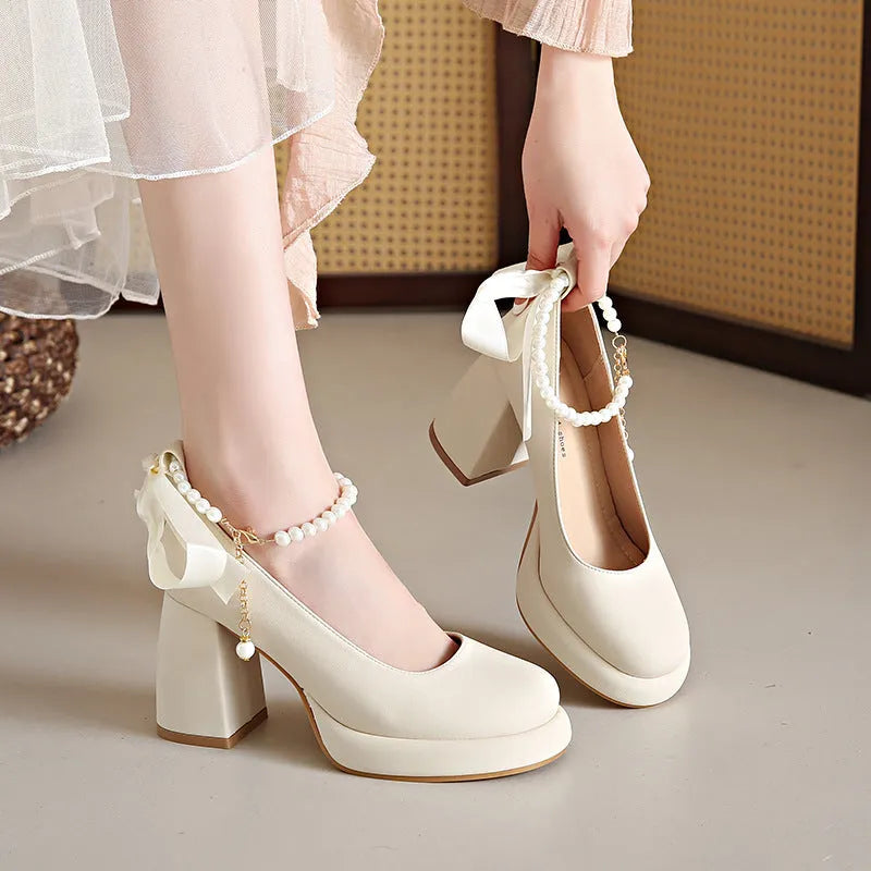 Women's beige Mary Jane shoes with chunky heel and ankle strap buckle showing round toe design