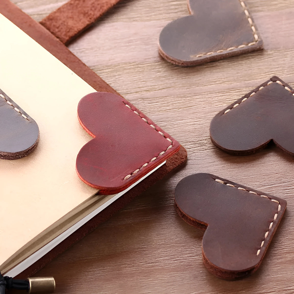 Heart-shaped bookmark in brown crazy horse leather with textured surface and handmade edges