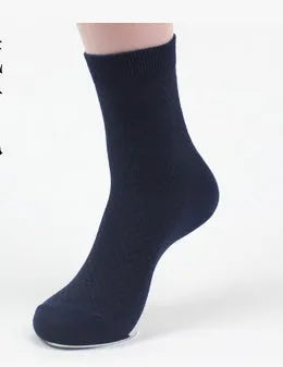Men's bamboo fibre ankle socks in black with a small square pattern, laid flat.