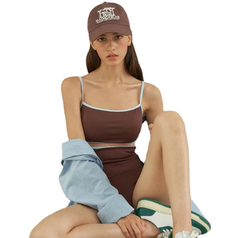 Brown women's one-piece swimsuit with triangle halter neck on a mannequin.