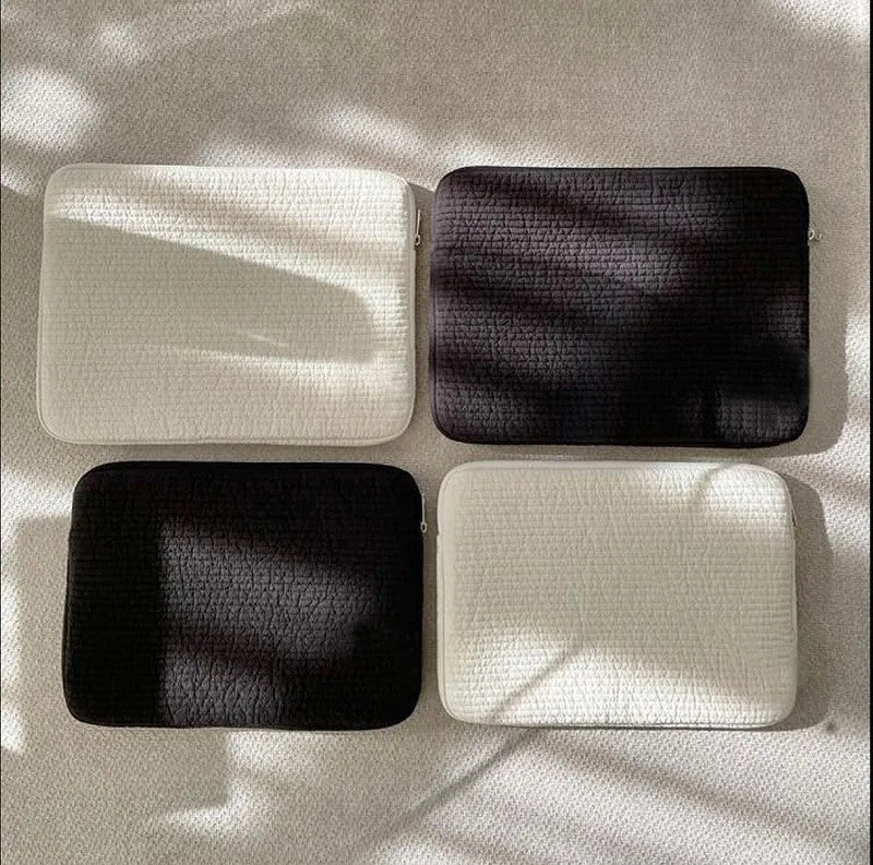 Black and white cotton cloth hand-held clutch bag for anti-seismic tablet protection.