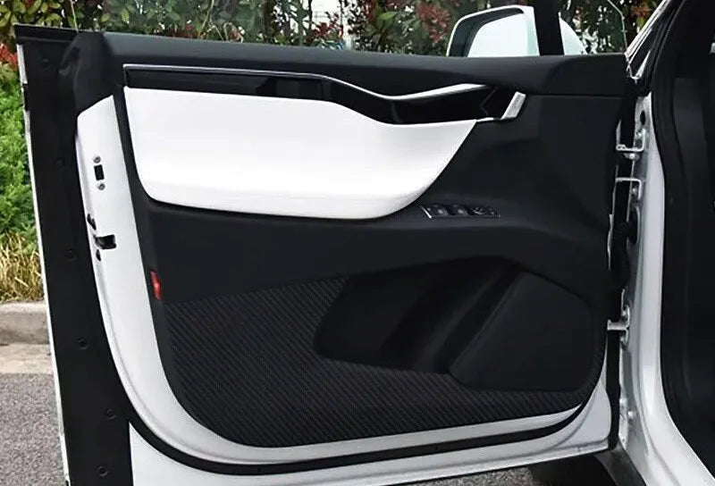 Four-piece clear protective film kit for Tesla Model S car door control panels.