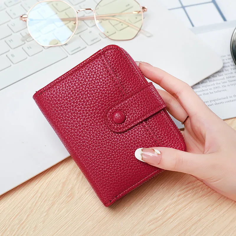 Beige ladies short wallet with a textured lychee pattern, shown in a two-fold open position.