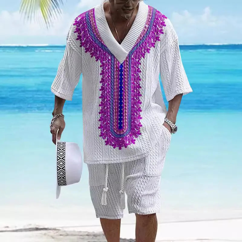 Man wearing a printed drop-shoulder knitted short-sleeved top with matching shorts in a solid colour.