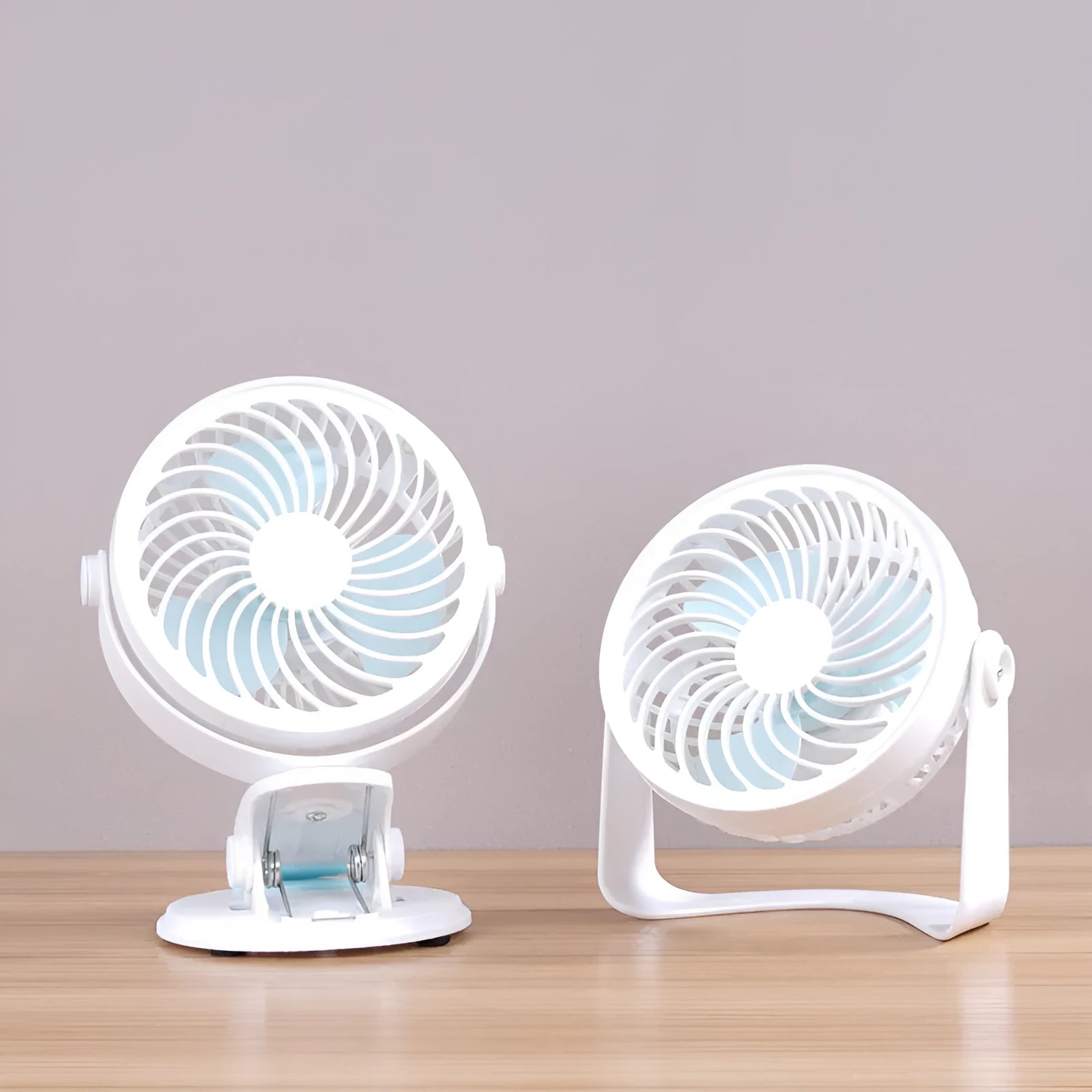 Small USB desktop fan in white plastic with three blades, shown as both clip-mounted and floor-standing versions