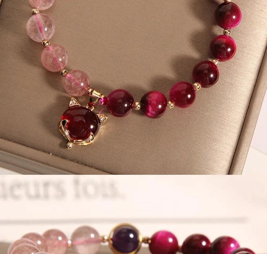 Simple women's bracelet made of transparent strawberry crystal beads on a black elastic rope.