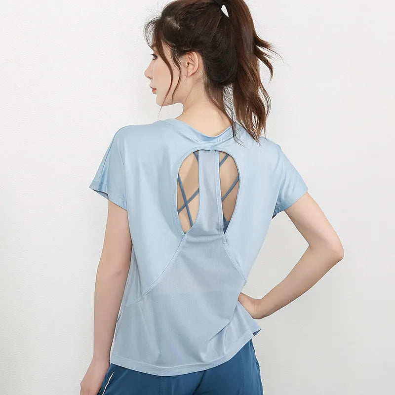 Ladies short sleeve polyester sports T-shirt in pink, shown on a hanger.