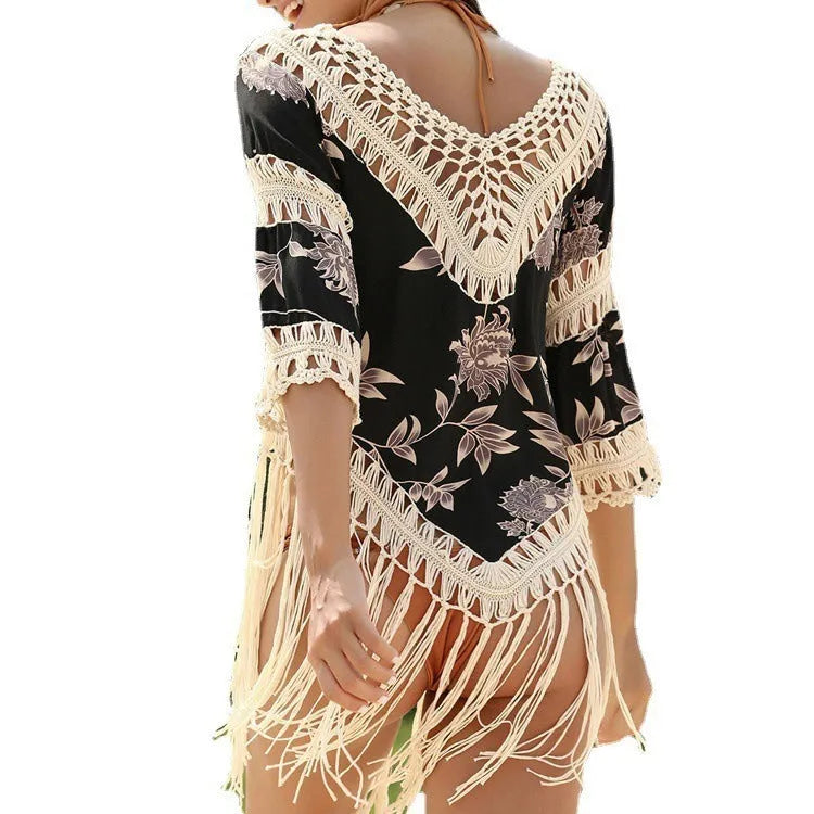 Women's apricot V-neck long sleeve sun protection blouse with hollow-out fabric on a beach.