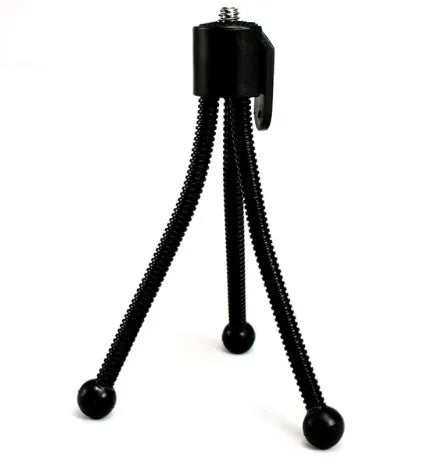 Small black iron mini tripod with telescopic legs and a universal ball head, shown holding an iPhone.