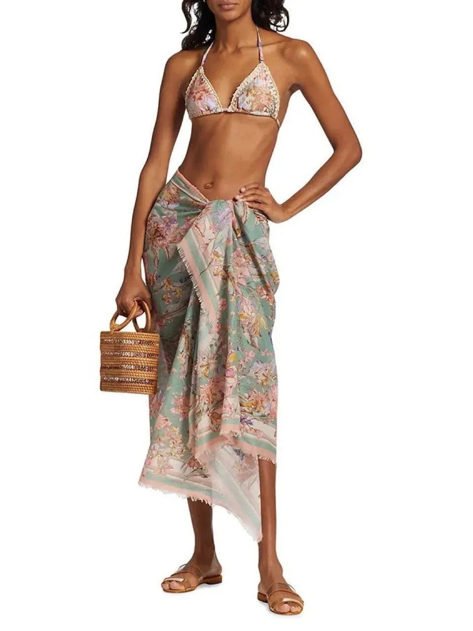 Women's creamy white floral bikini set with halter top, briefs, and a detachable ruffled skirt.