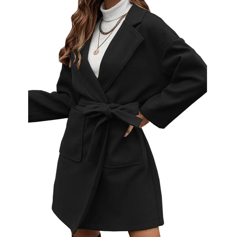 Long sleeve brown lapel button coat with belt and split back, loose fit on a hanger.