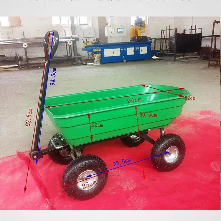 Green TC2145 four-wheel toy dump truck with steel frame and plastic body in a garden setting.
