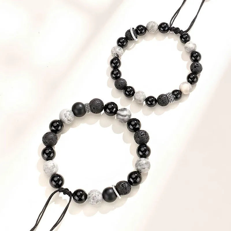Black agate map stone volcanic rock bracelet with diamond-shaped cuts on wrist.