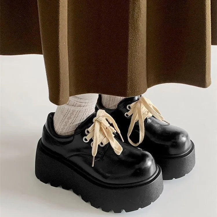 Matte black women's lace-up shoes with a chunky rubber sole and 6-8cm heel.