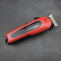 Professional digital hair clipper in black, red, or white with charger and four attachment combs.