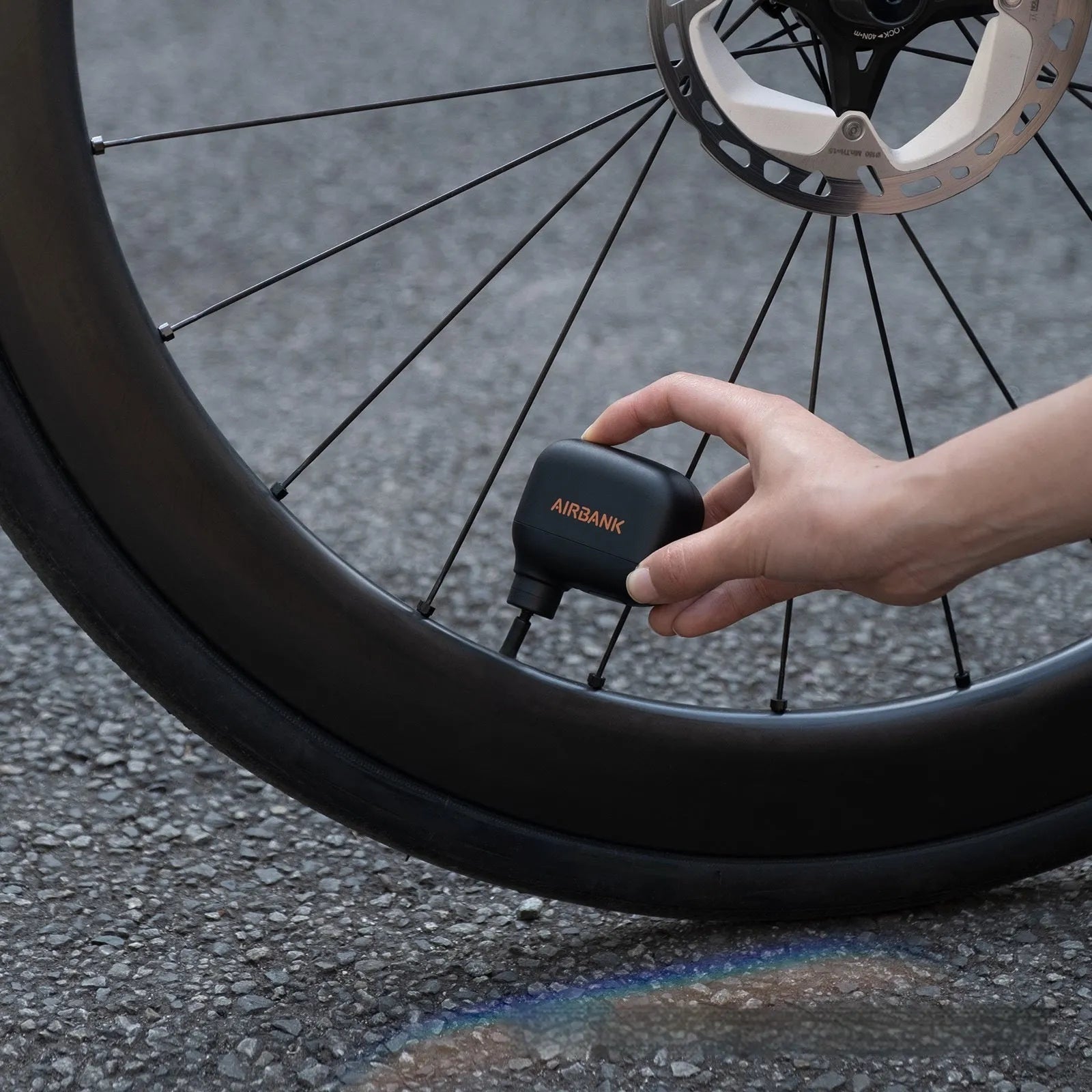Black AS100 electric bicycle tyre pump with USB charging cable and waterproof storage bag