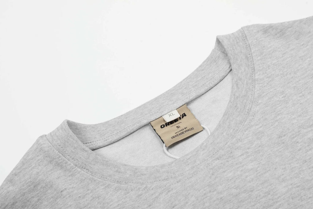 Men's grey loose fit cotton long sleeve pullover top on a hanger